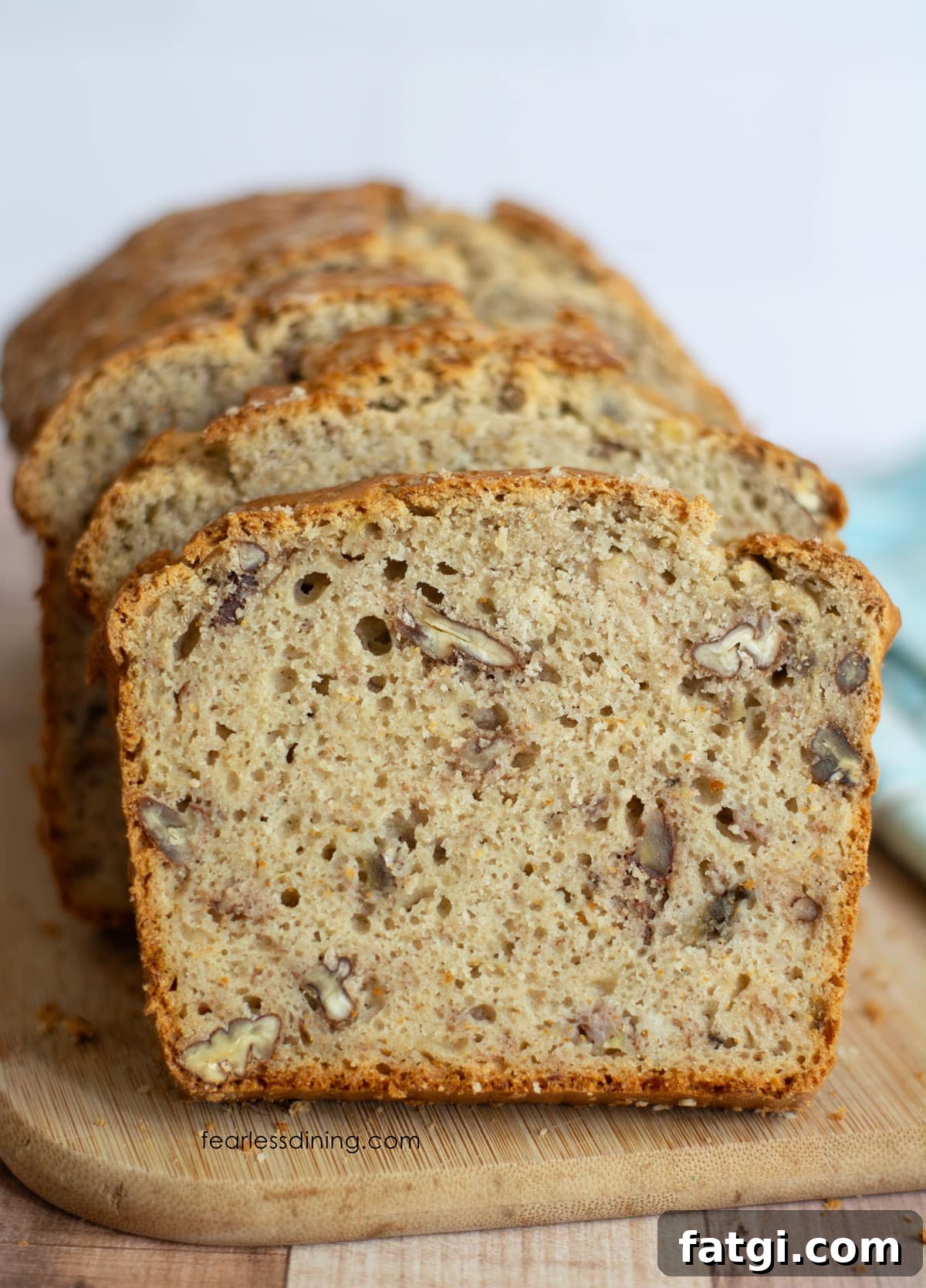 A sliced loaf of gluten-free sourdough banana bread on a cutting board.