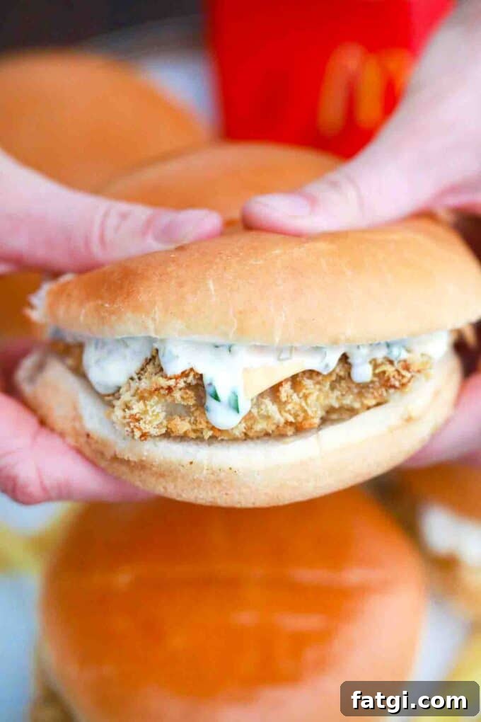 Copycat McDonald's Filet-O-Fish Sandwich Recipe 7 holding a McDonald's fish sandwich