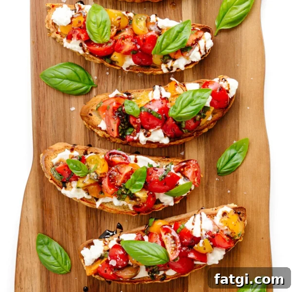 Burrata Bruschetta with tomato basil topping on a wooden board.