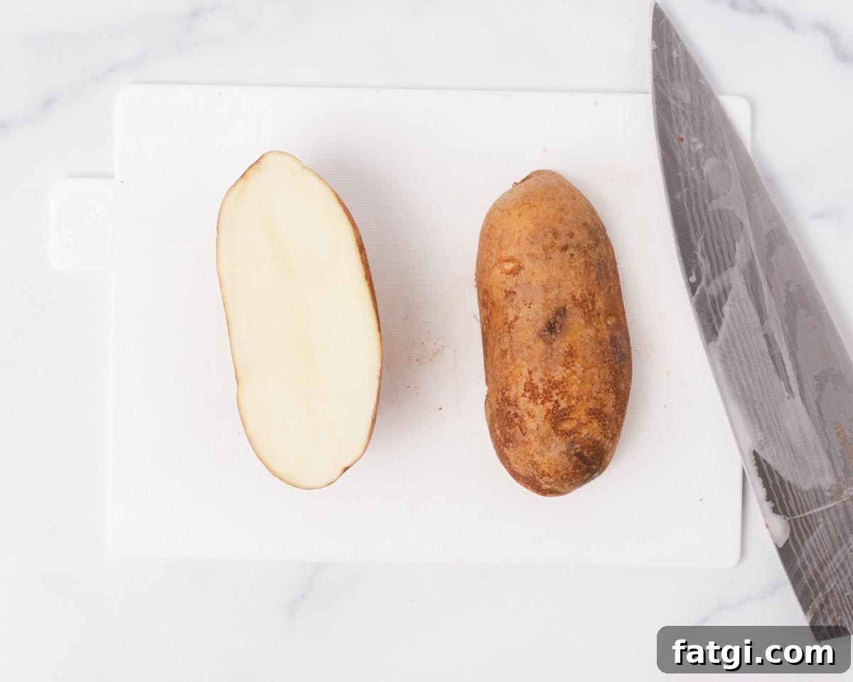 Crispy Air Fryer Potato Wedges 4 Cutting potato in half.