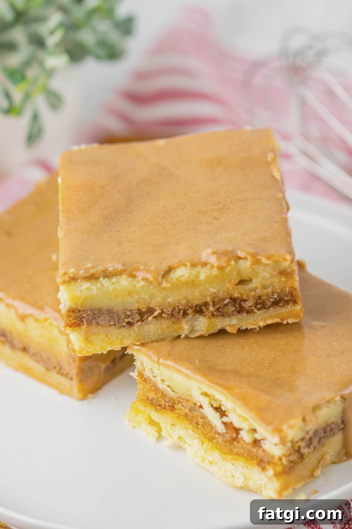 Three brown butter cinnamon bars on a small plate.