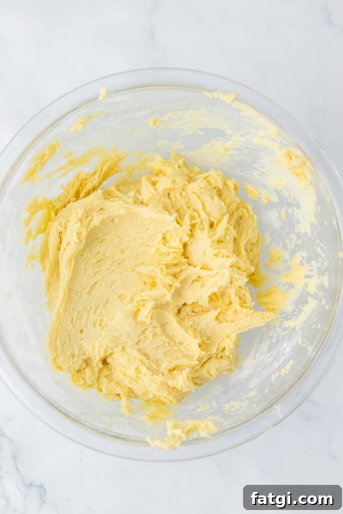 Dough being mixed in a glass mixing bowl.