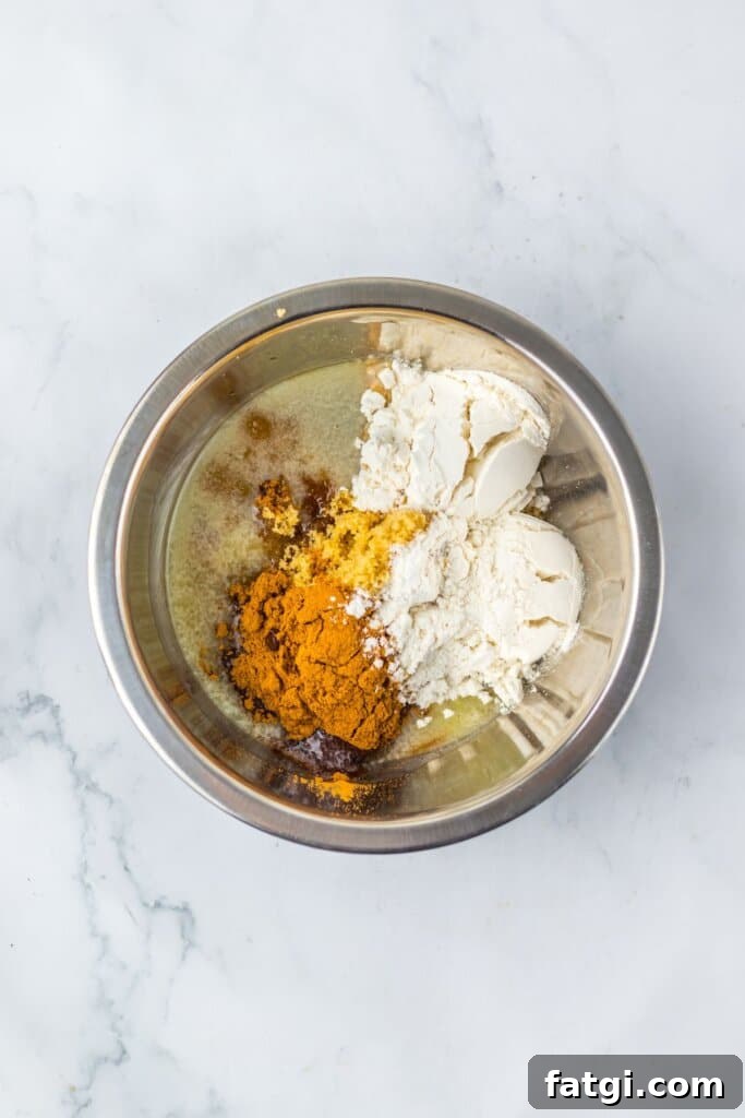 Filling ingredients being mixed in a stainless steel mixing bowl.