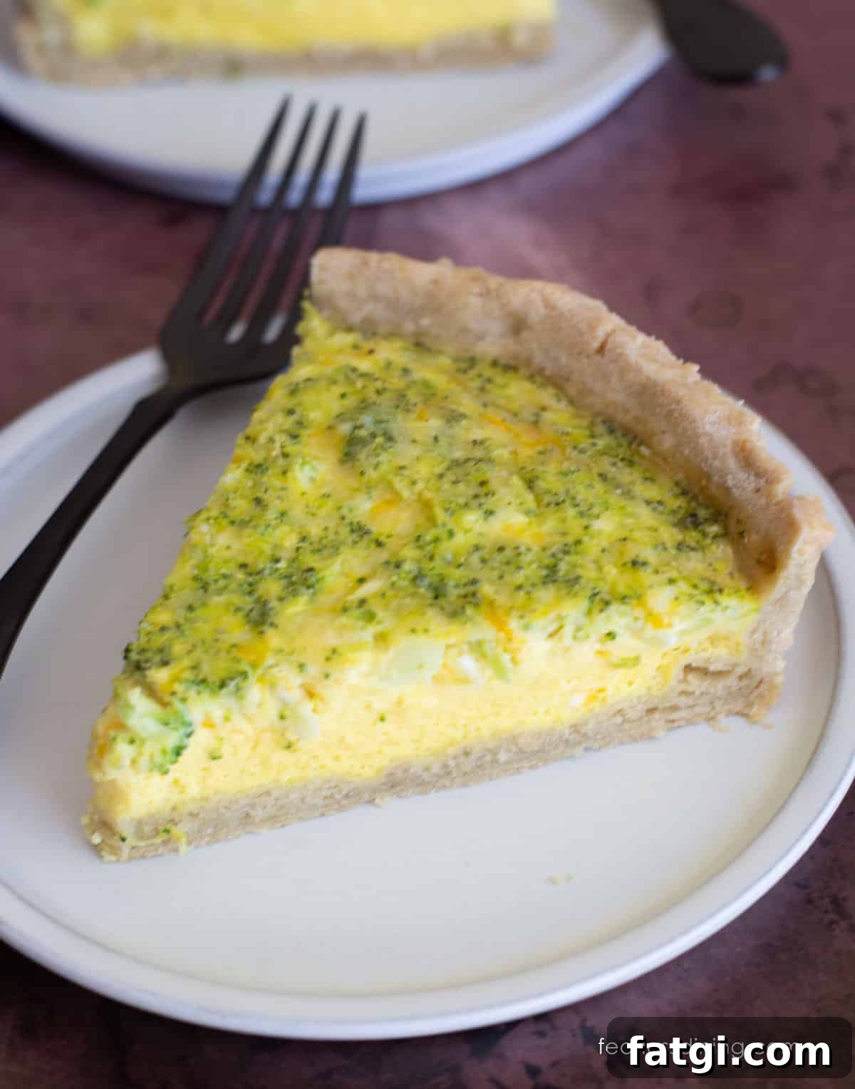 A slice of gluten-free quiche loaded with cheddar and broccoli.