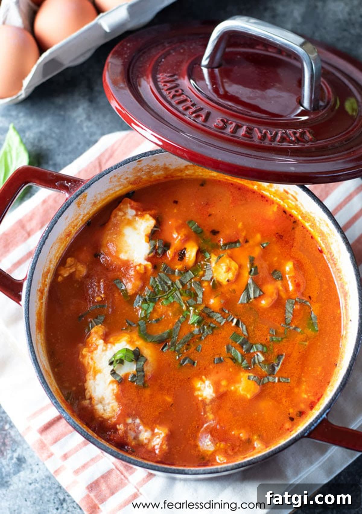 A red Dutch oven filled with cooked shakshuka.