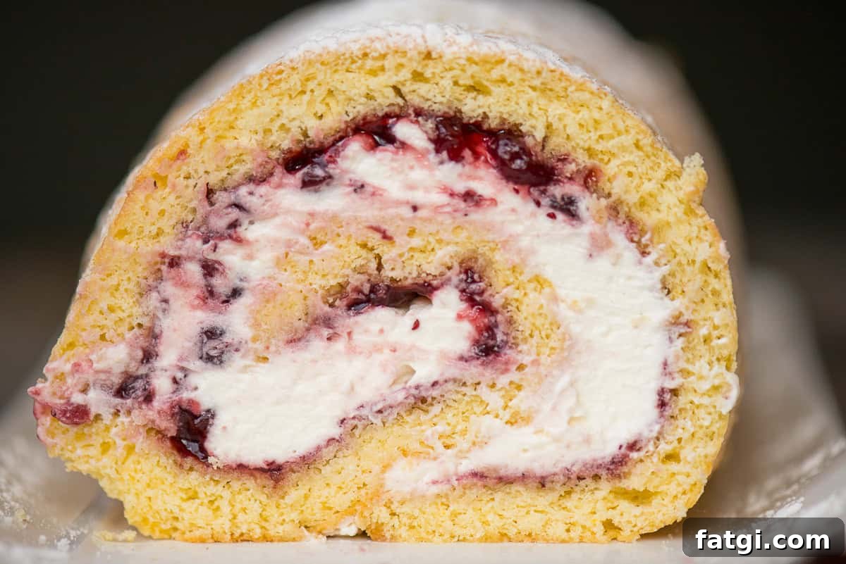 slice of lemon berry cake roll with cream filling.