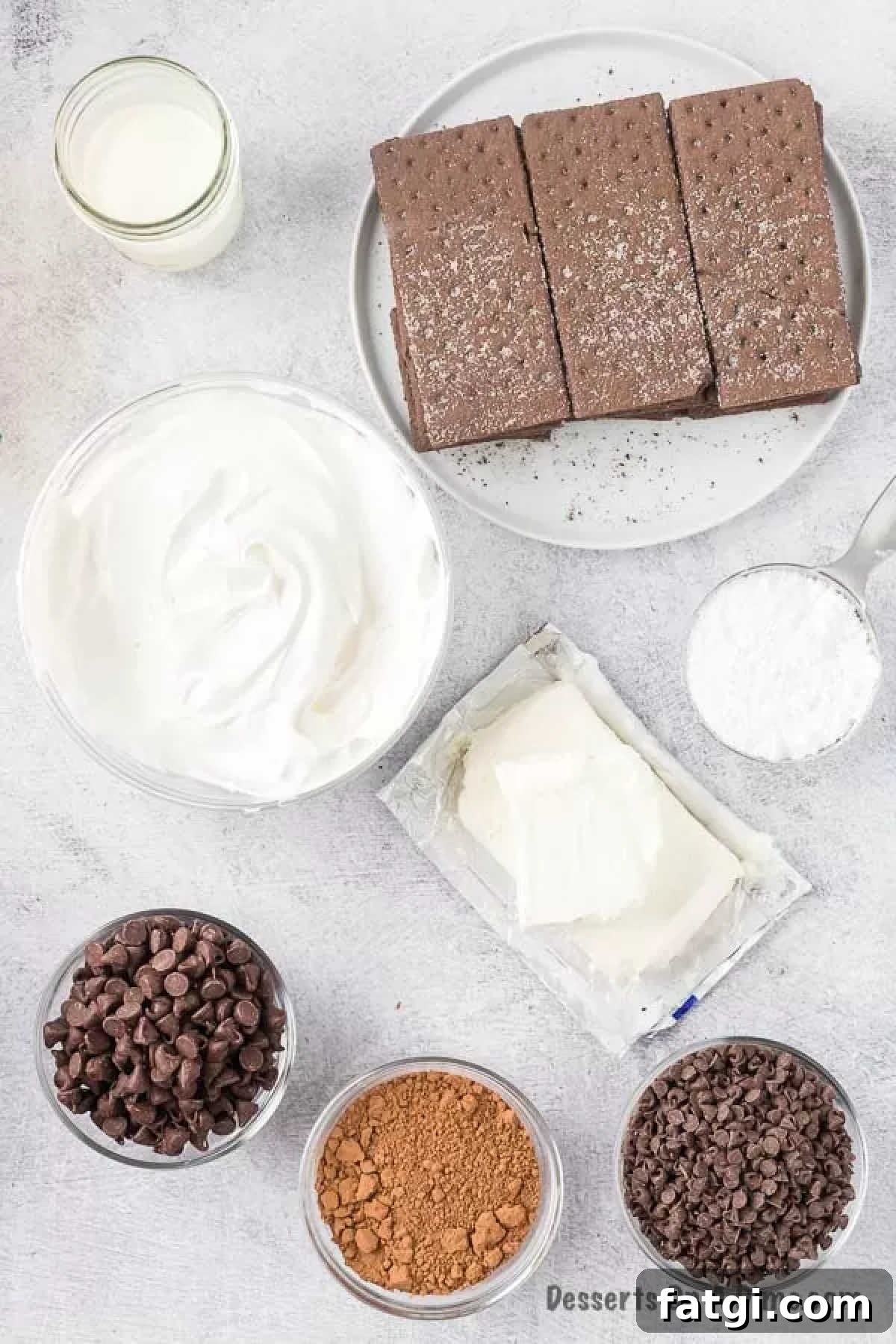 Ingredients for Chocolate Ice Box Cake - chocolate graham crackers, cream cheese, powdered sugar, cool whip, heavy cream, chocolate chips. 