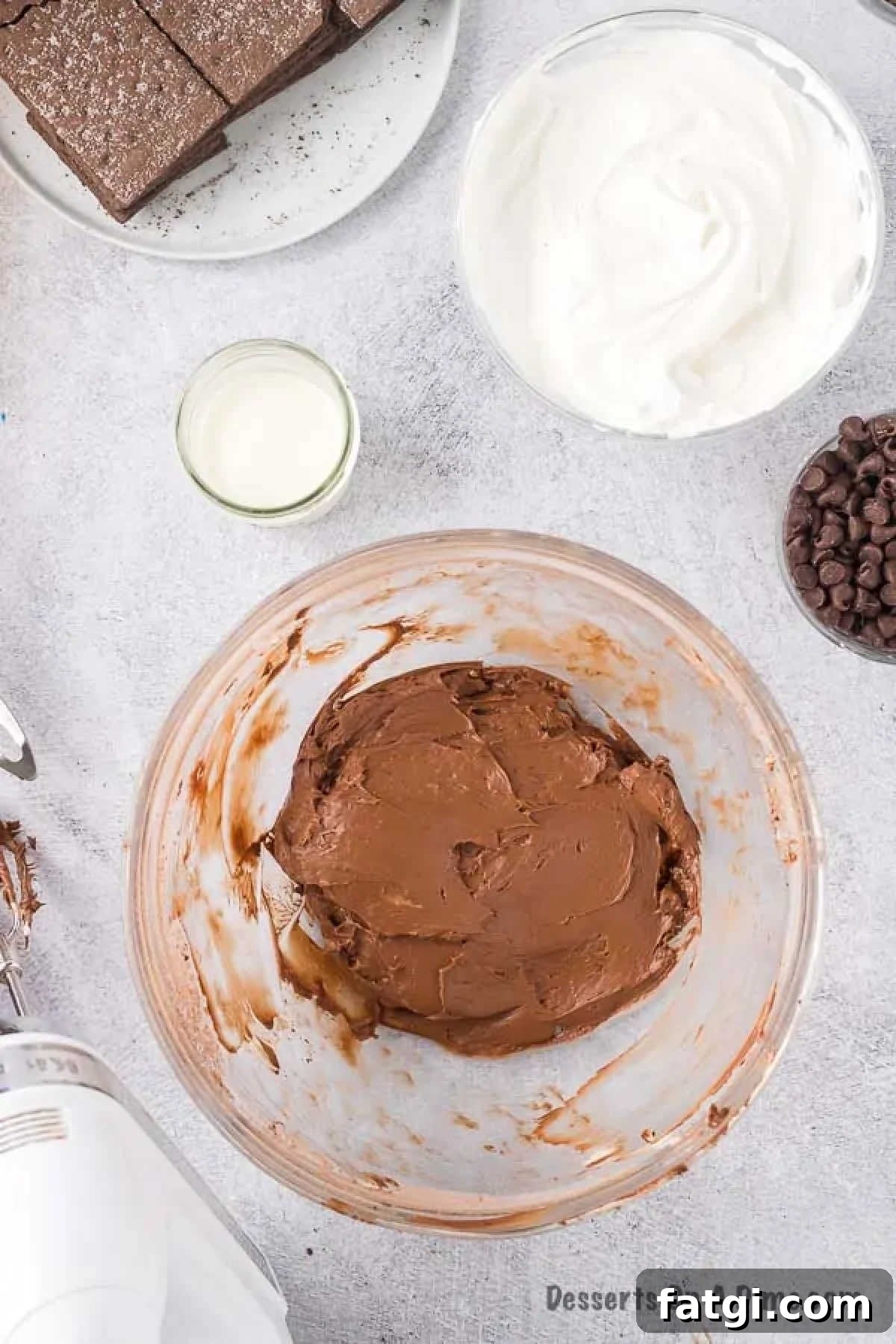 Cream cheese mixture in a bowl with powdered sugar. 