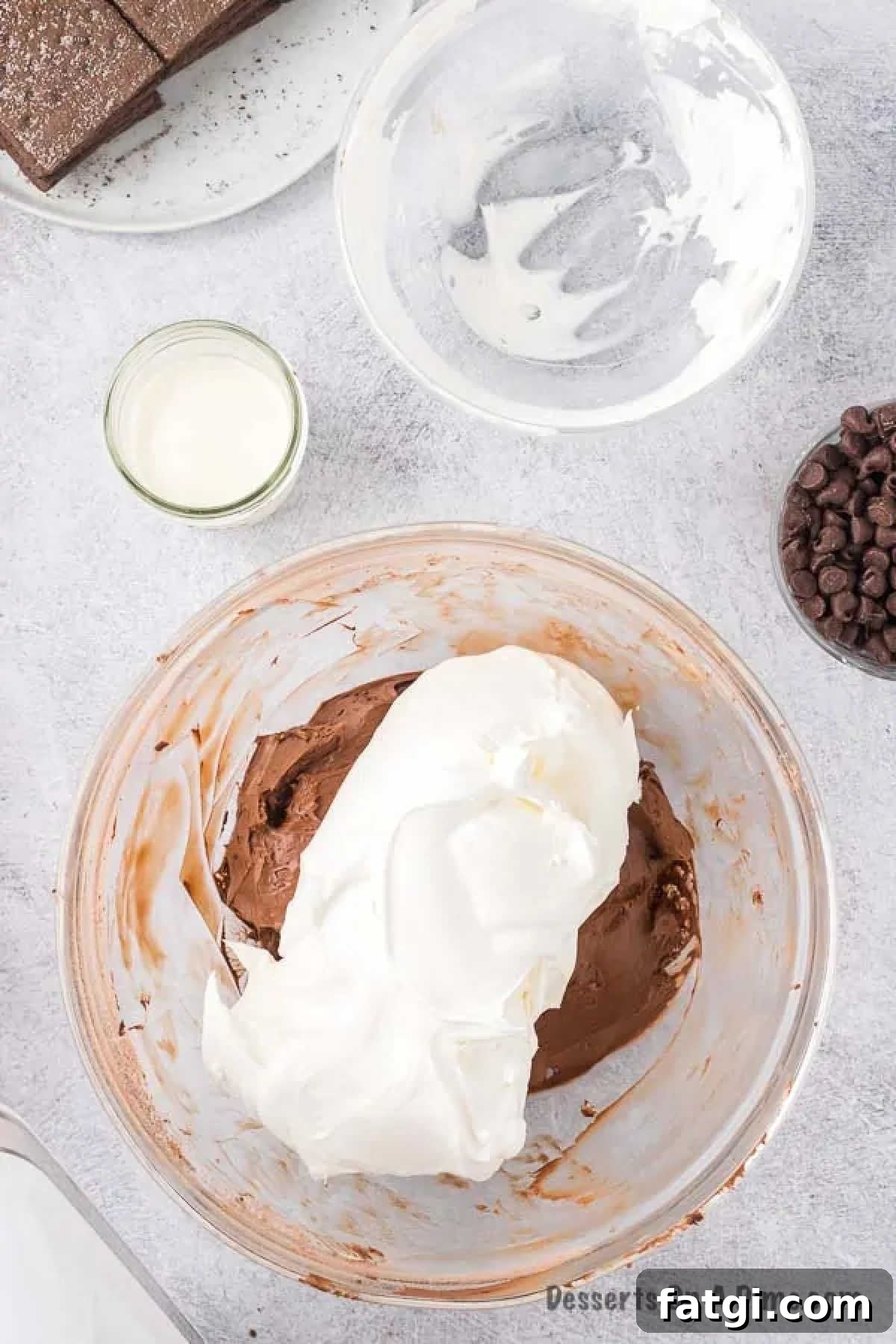 Whipped cream folded into bowl. 