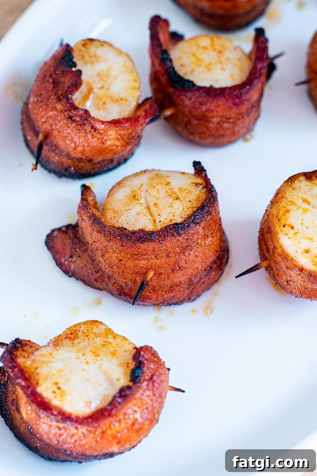 Sweet and Smoky Bacon Wrapped Scallops Recipe 2 Perfect golden brown bacon-wrapped scallops with slight charred bacon edges.
