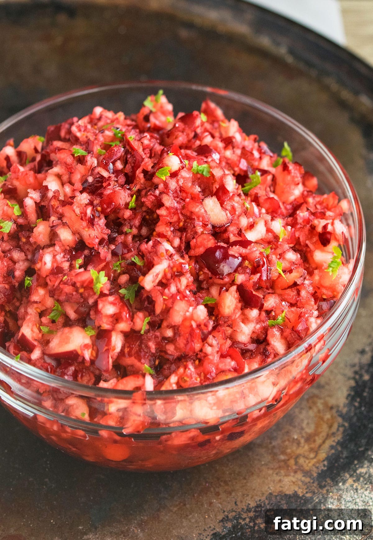 Easy one bowl fresh cranberry relish in a glass bowl.