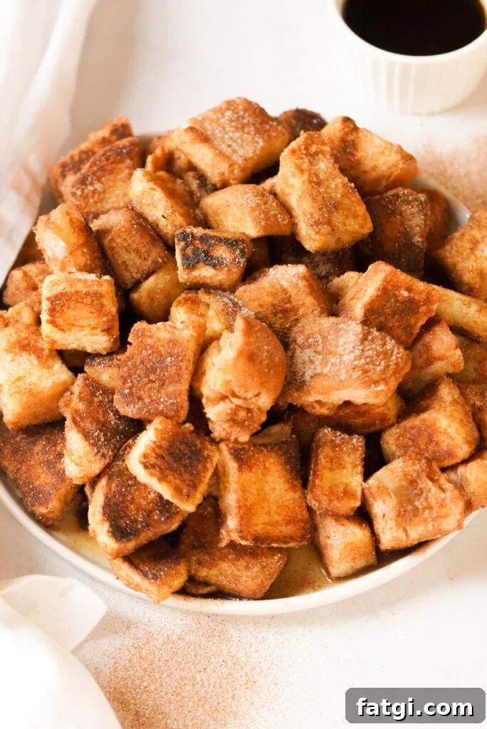 plate with cinnamon sugar french toast cubes and maple syrup on the side