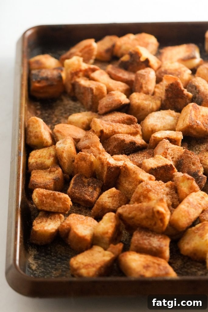 french toast bites with cinnamon sugar on a baking sheet