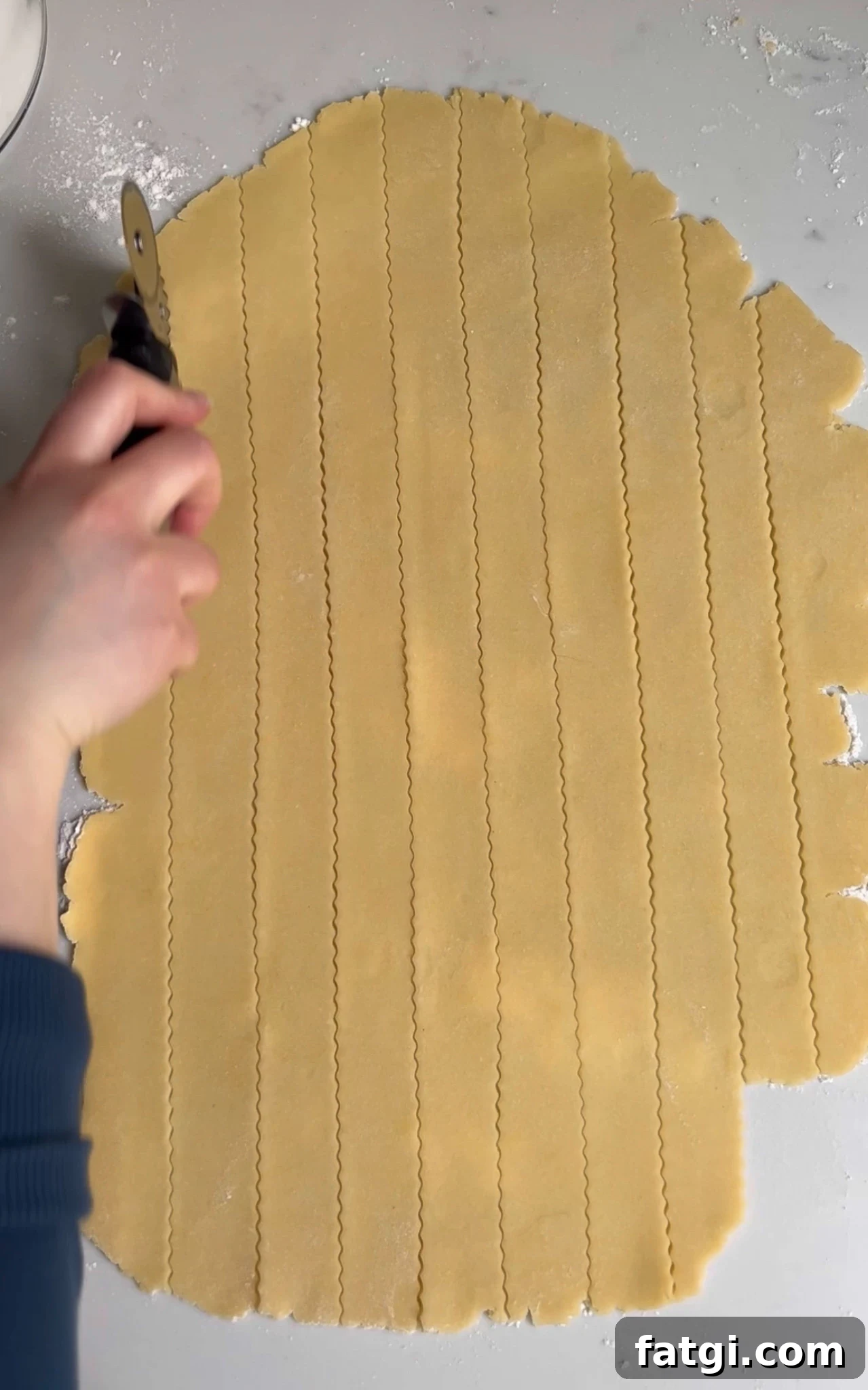 Cutting strips of pastry for a lattice.