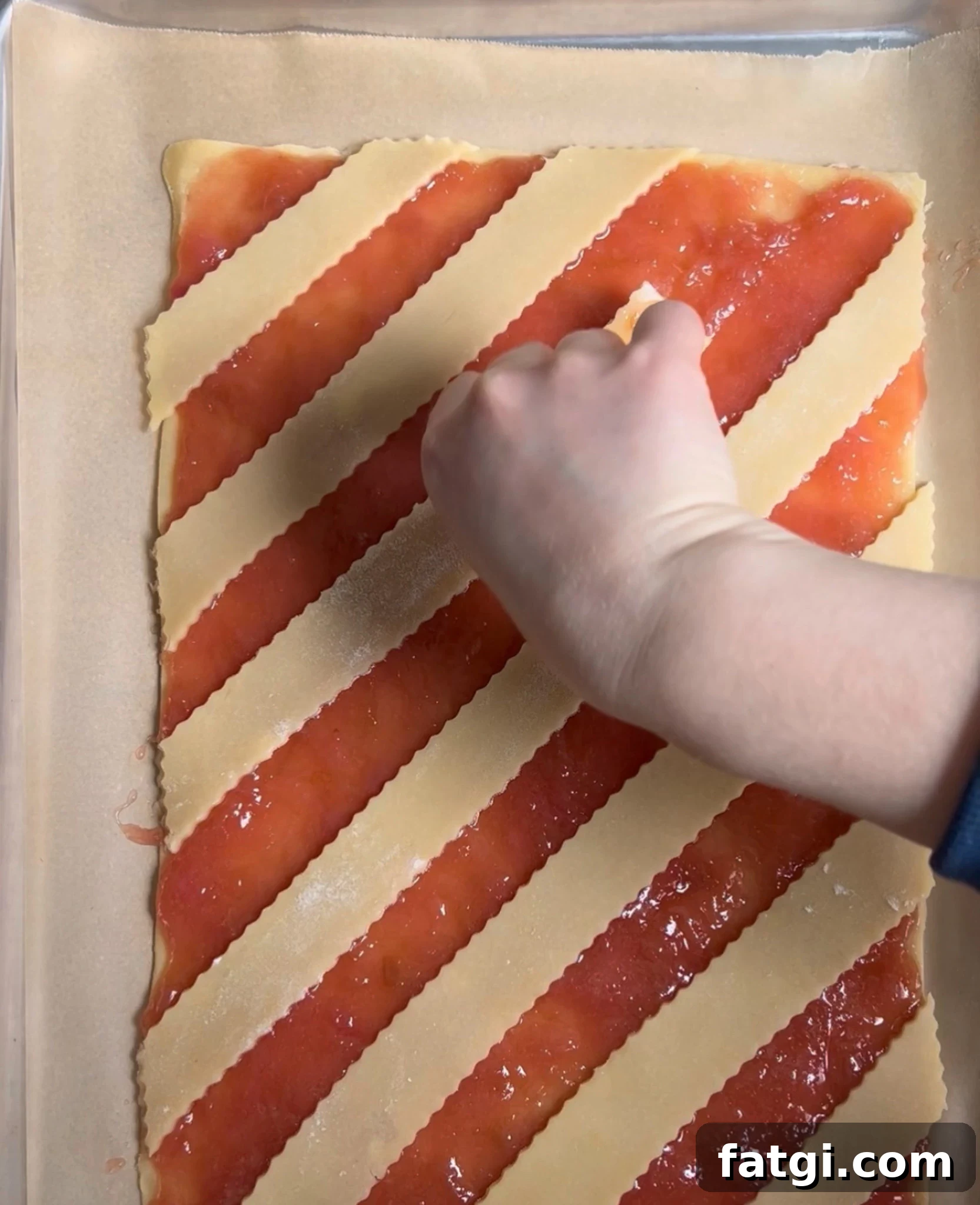 Creating a diagonal lattice on a rhubarb pastry.