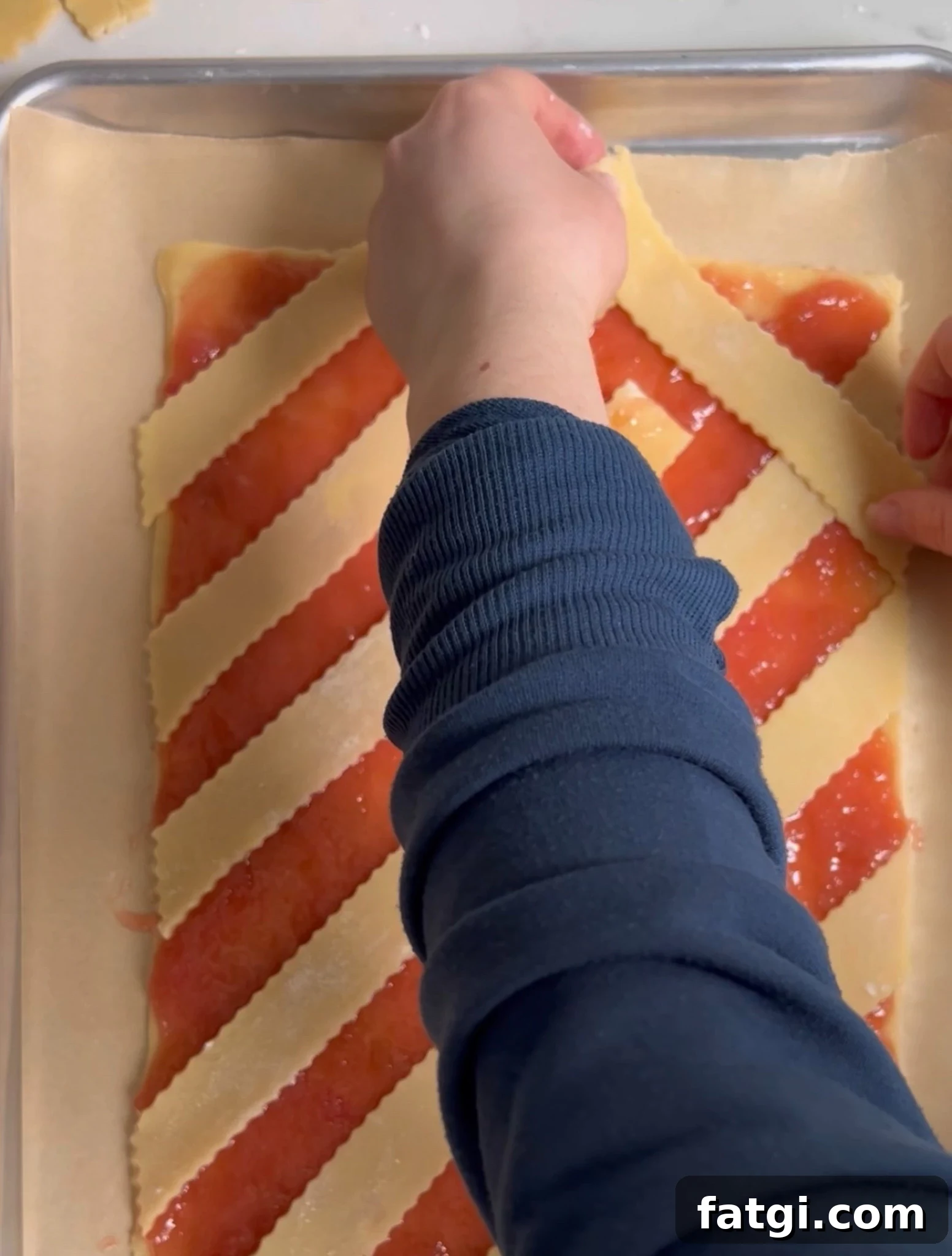 Creating a diagonal lattice on a rhubarb pastry.
