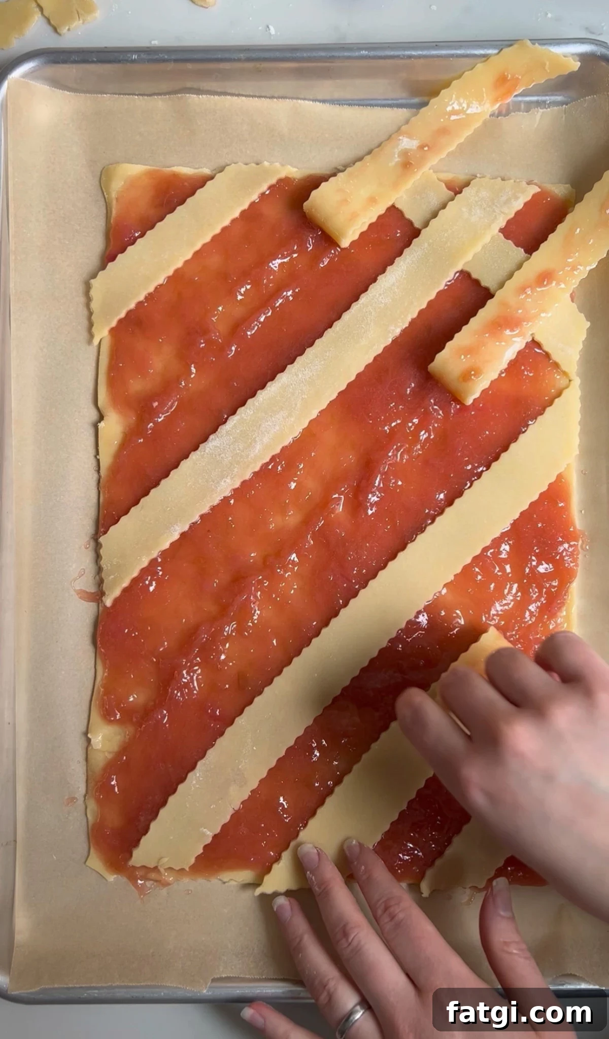 Creating a diagonal lattice on a rhubarb pastry.