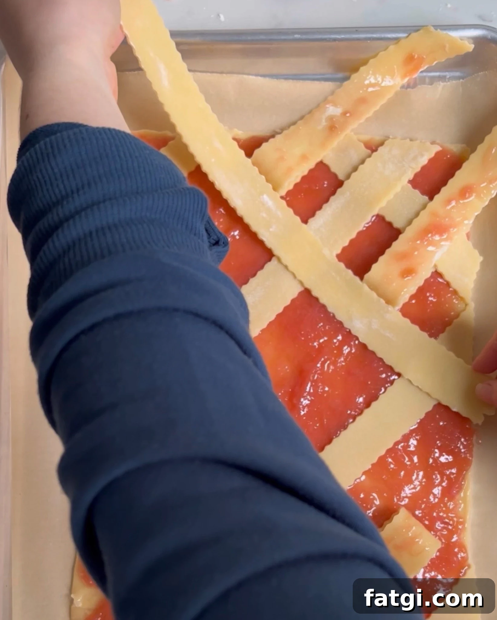 Creating a diagonal lattice on a rhubarb pastry.