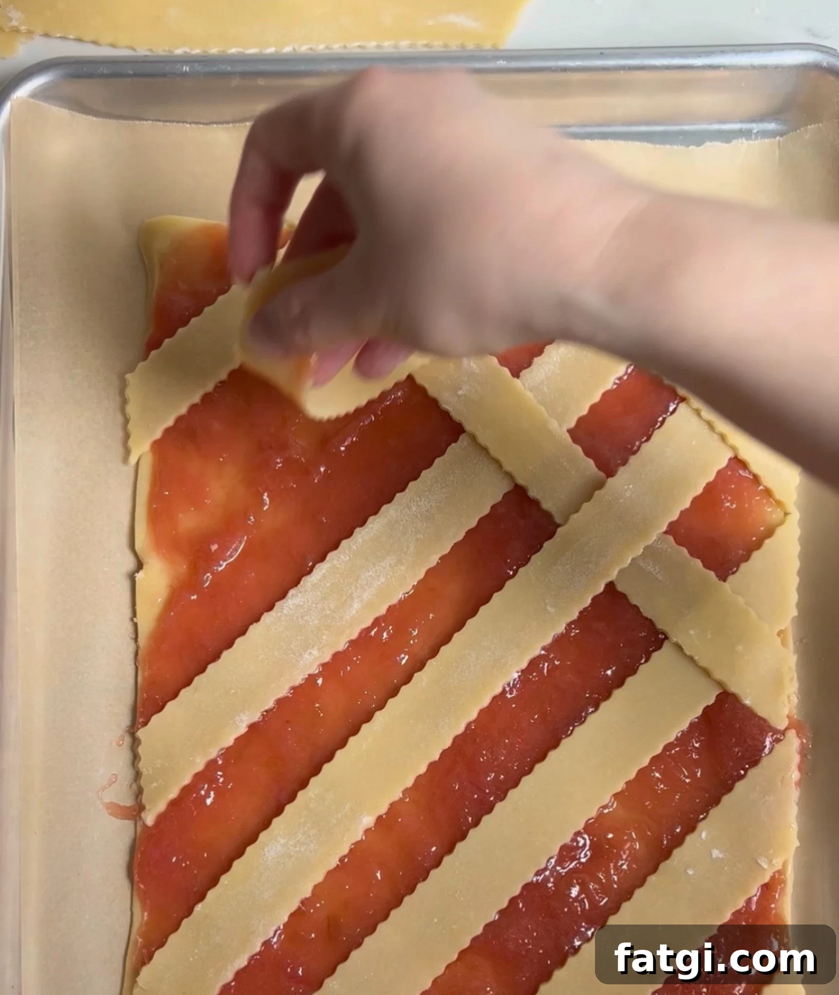 Creating a diagonal lattice on a rhubarb pastry.