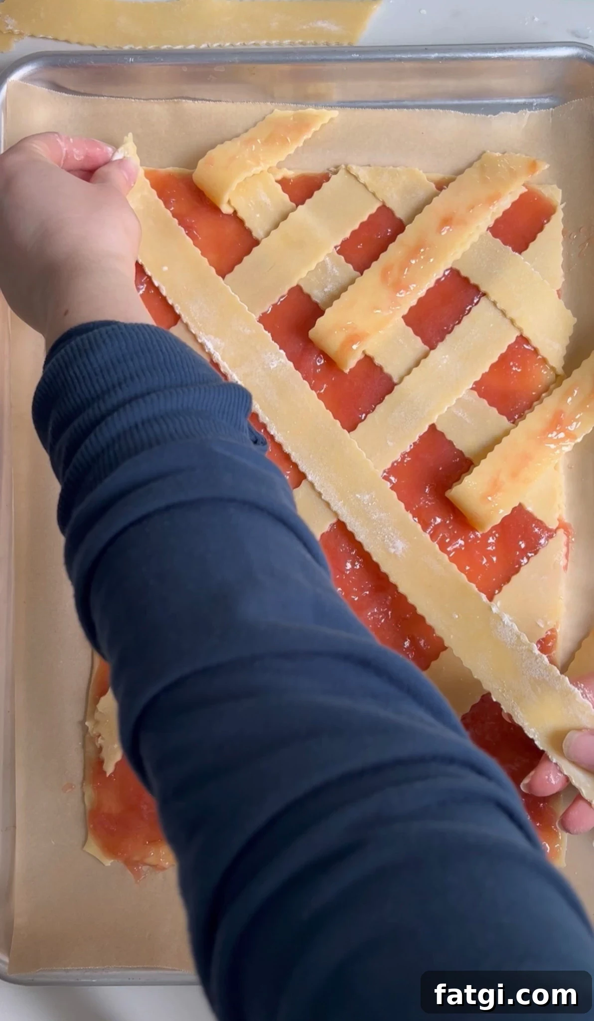 Creating a diagonal lattice on a rhubarb pastry.