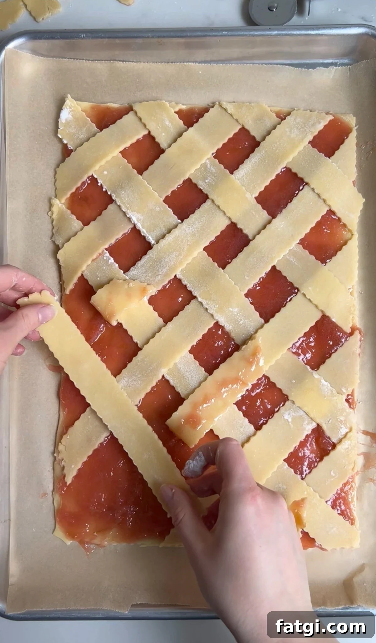 Creating a diagonal lattice on a rhubarb pastry.