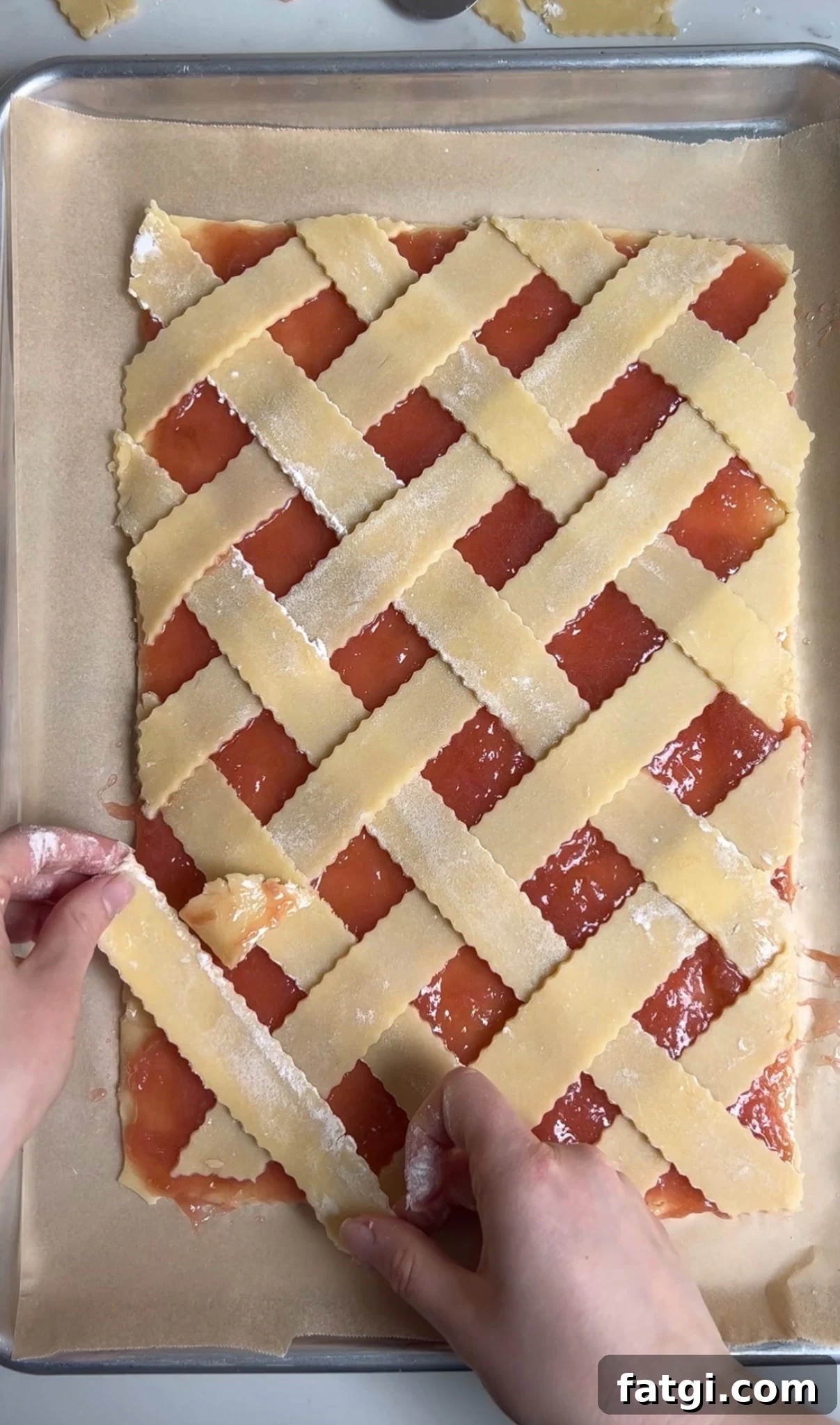 Creating a diagonal lattice on a rhubarb pastry.