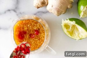 Whisking a chili, lime, and ginger dressing in a bowl.