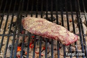 Grilling a steak over hot coals.