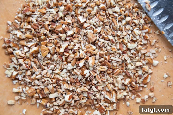 Homemade Cheese Log Recipe 6 chopped pecans on a cutting board.