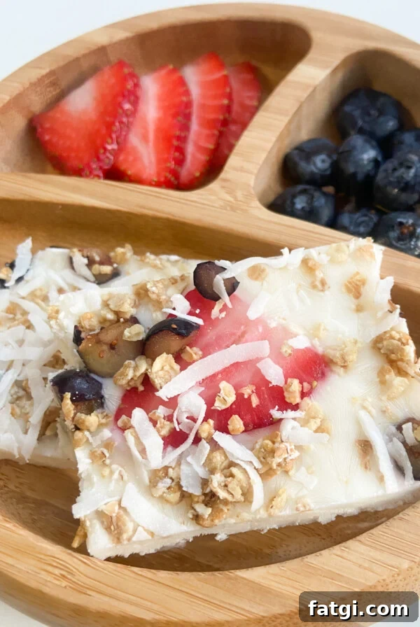 Frozen yogurt bark served with blueberries and strawberries