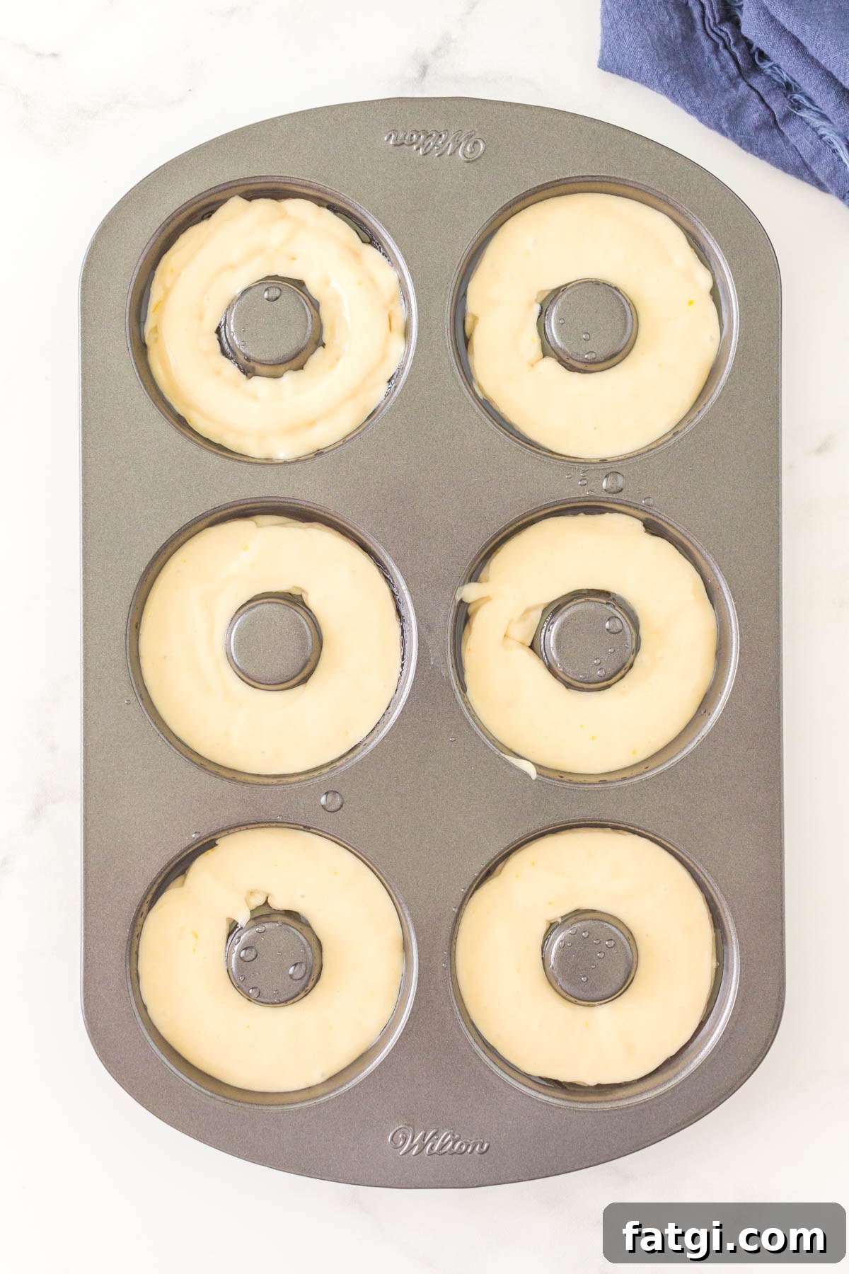 A donut pan filled with batter.