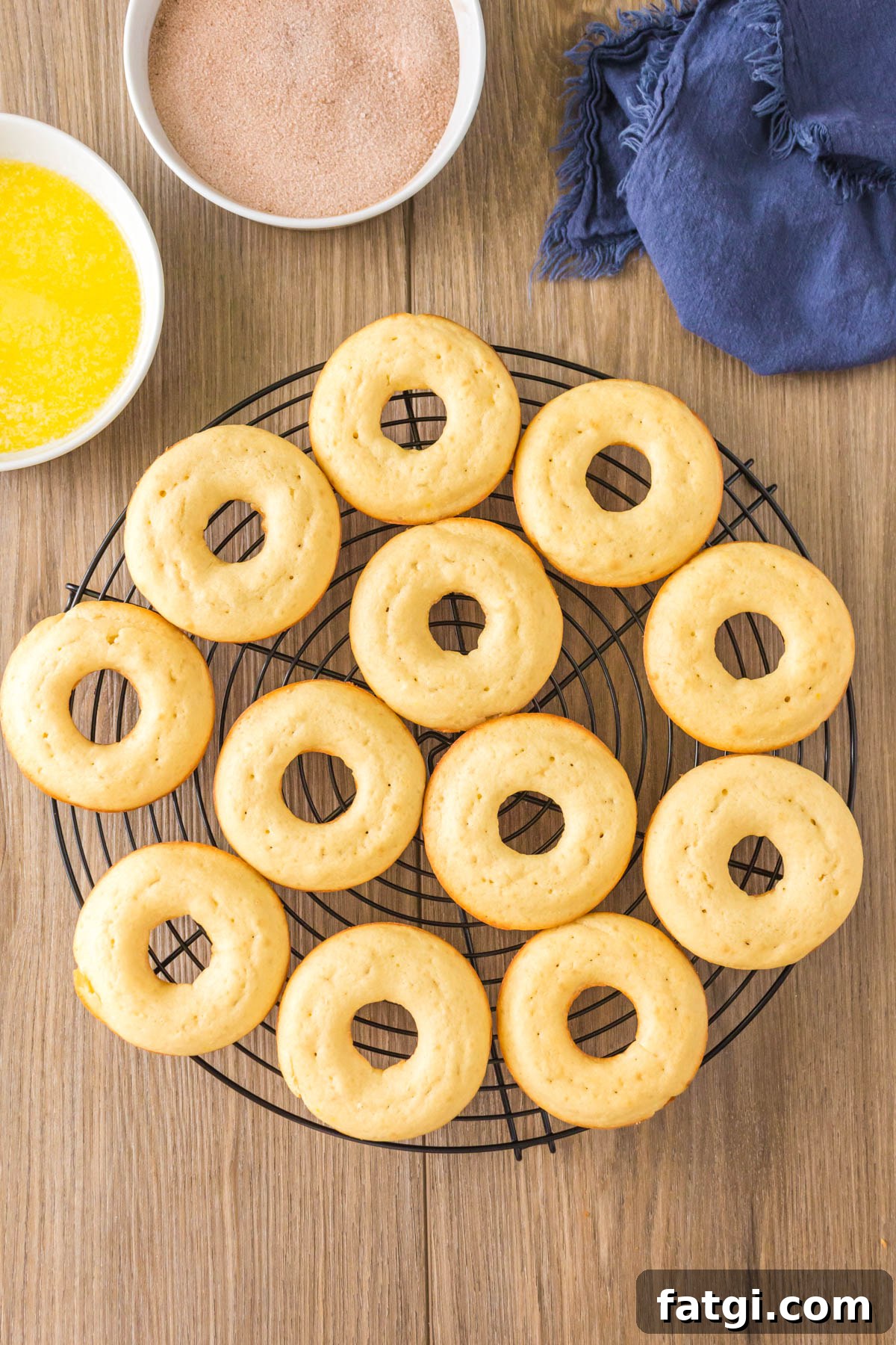 Baked donuts cooling on a cooling rack.