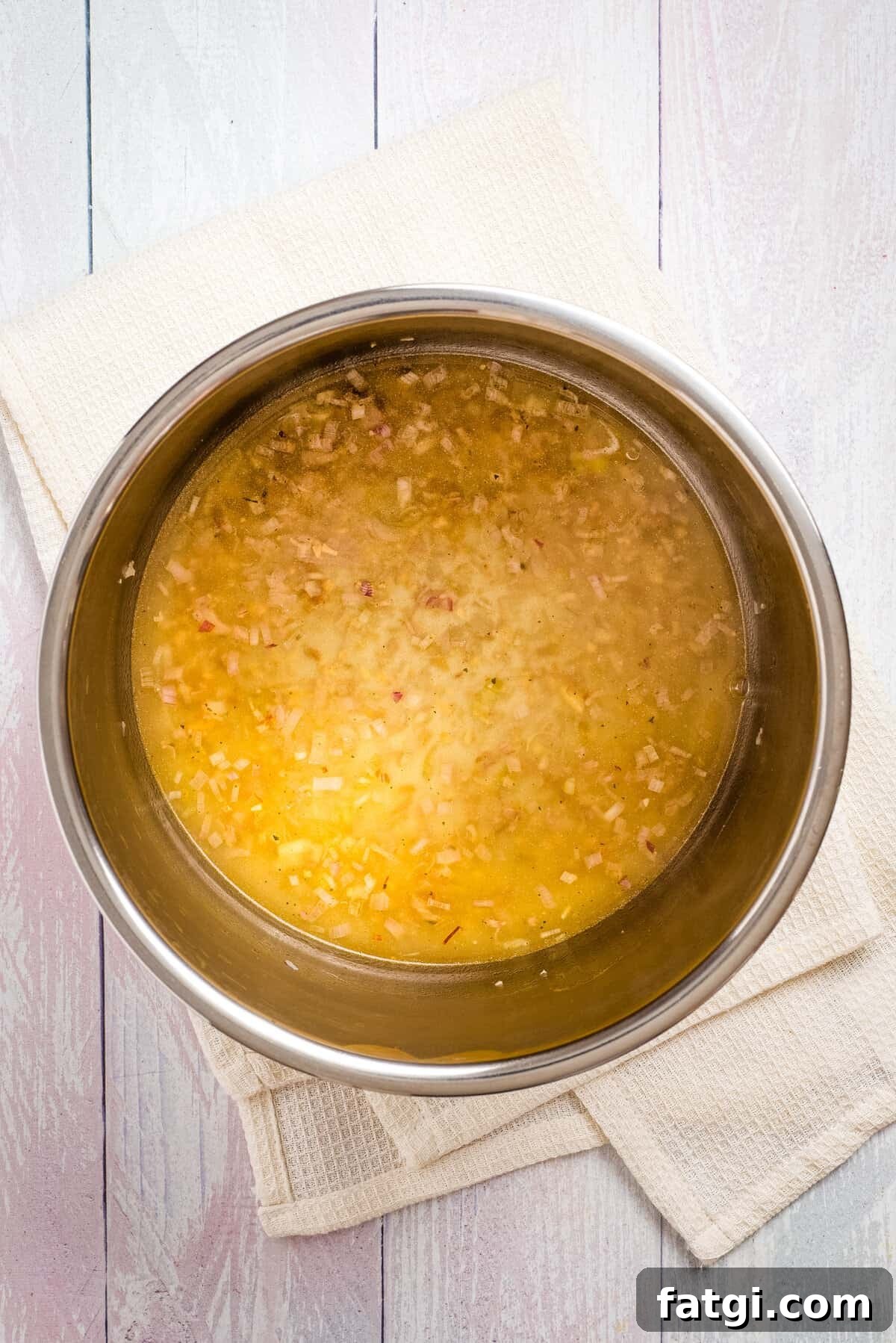 Instant Pot Tomato Soup with Fresh or Canned Tomatoes 6 Overhead view of uncooked instant pot tomato soup with vegetable broth.