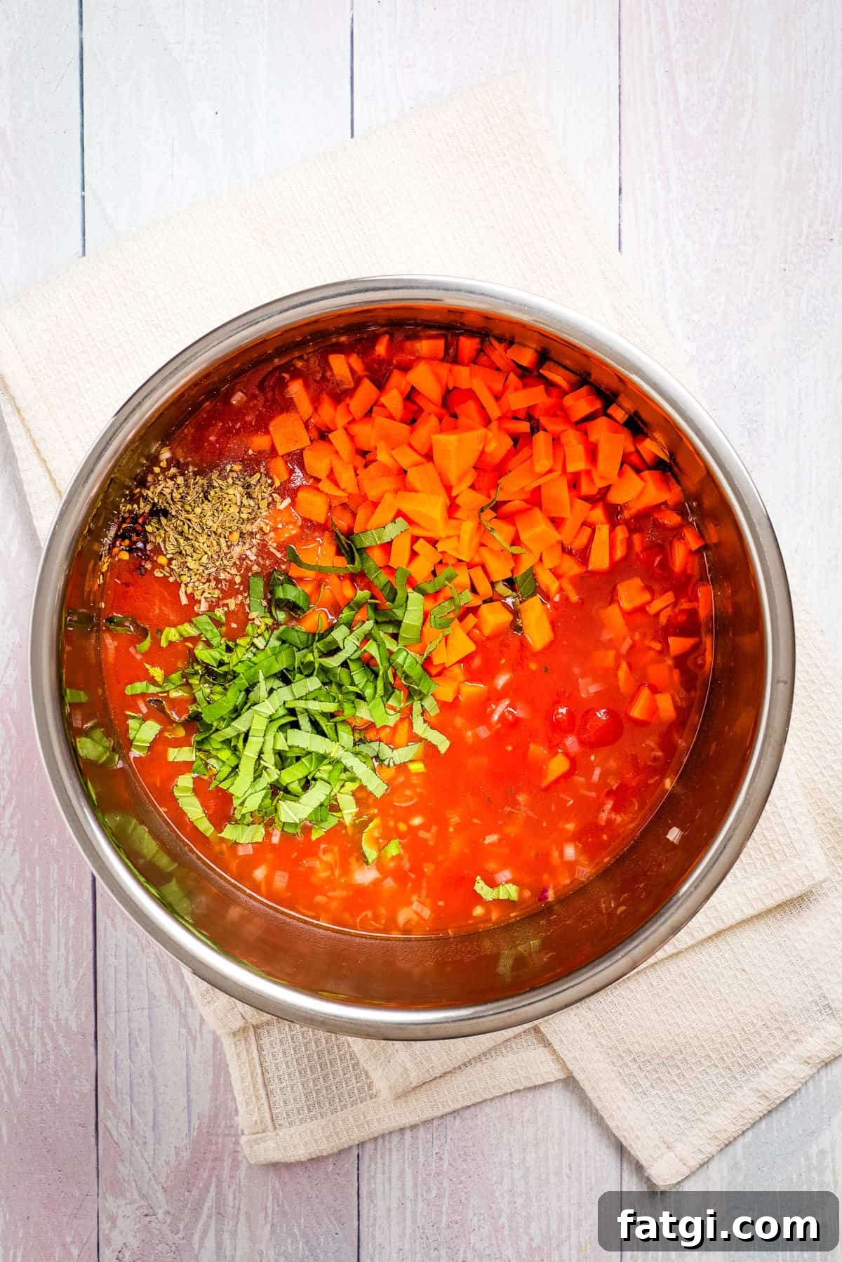 Instant Pot Tomato Soup with Fresh or Canned Tomatoes 7 Overhead view of uncooked instant pot tomato soup ingredients.