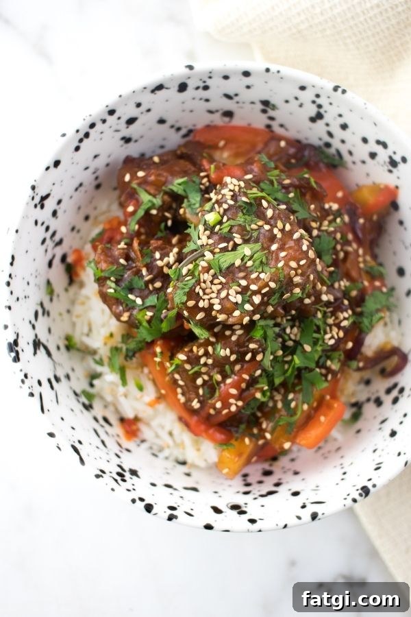Sweet and Sour Pork Kou Lou Yuk on white rice in a bowl