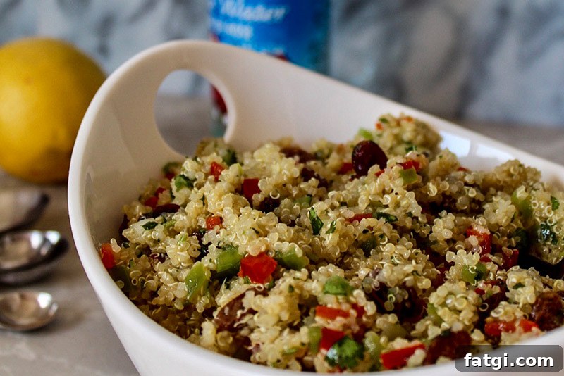 Refreshing Rose Water Quinoa Salad with Citrus & Feta 2 a close up of a big bowl filled with quinoa salad with fresh vegetables and raisins