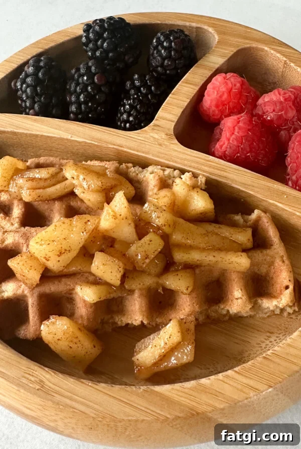 Cinnamon apple waffles topped with cinnamon apples.