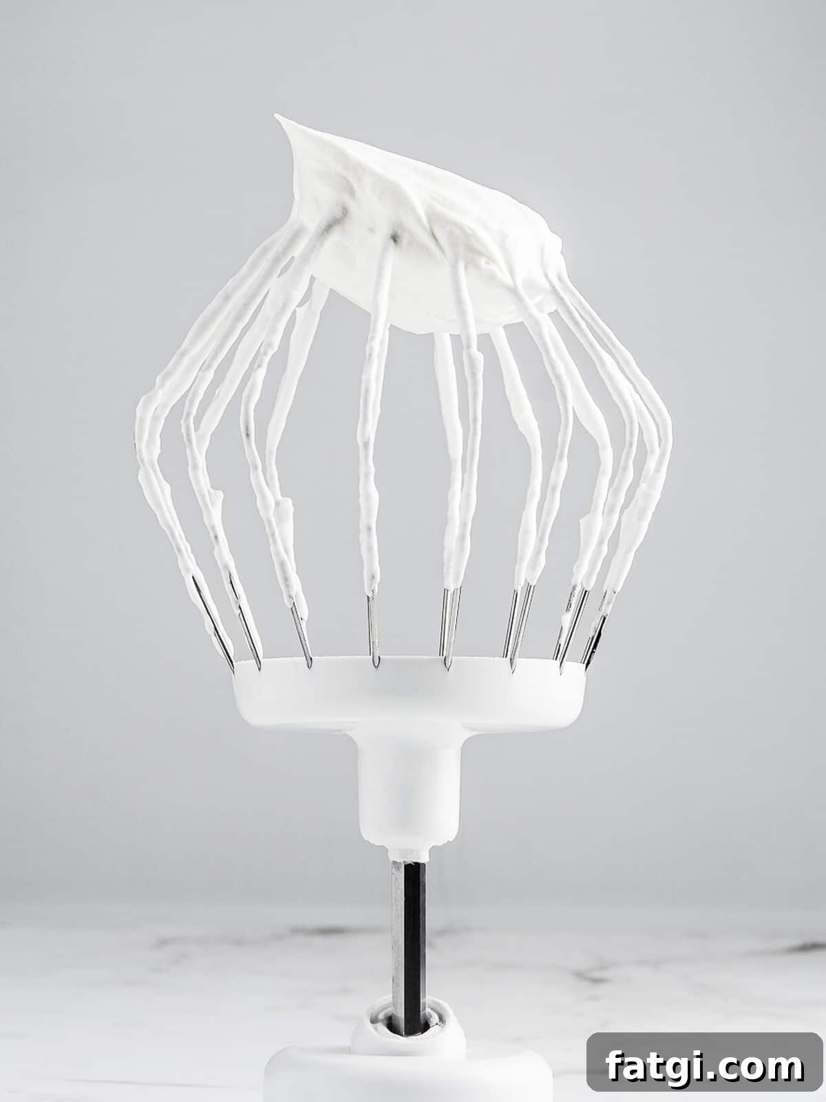 French Chantilly Cream Recipe 6 Chantilly cream with a stiff peak on a whisk attachment
