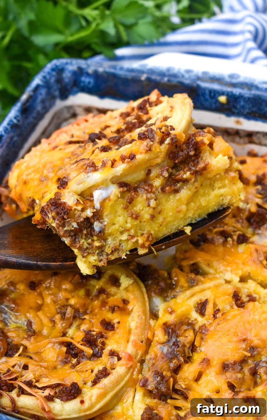 a wooden spatula lifting up a slice of frozen waffle bread pudding