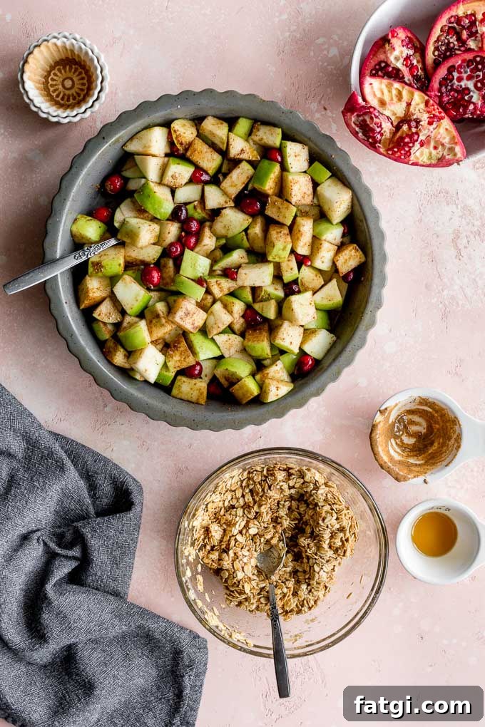 Ingredients for the apple filling in a pie plate with a bowl of the crisp topping off to the side.