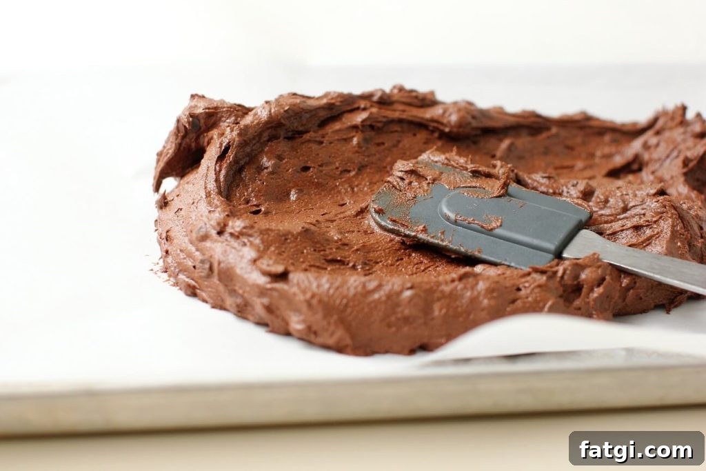 spreading the brownie brittle dough in the pan