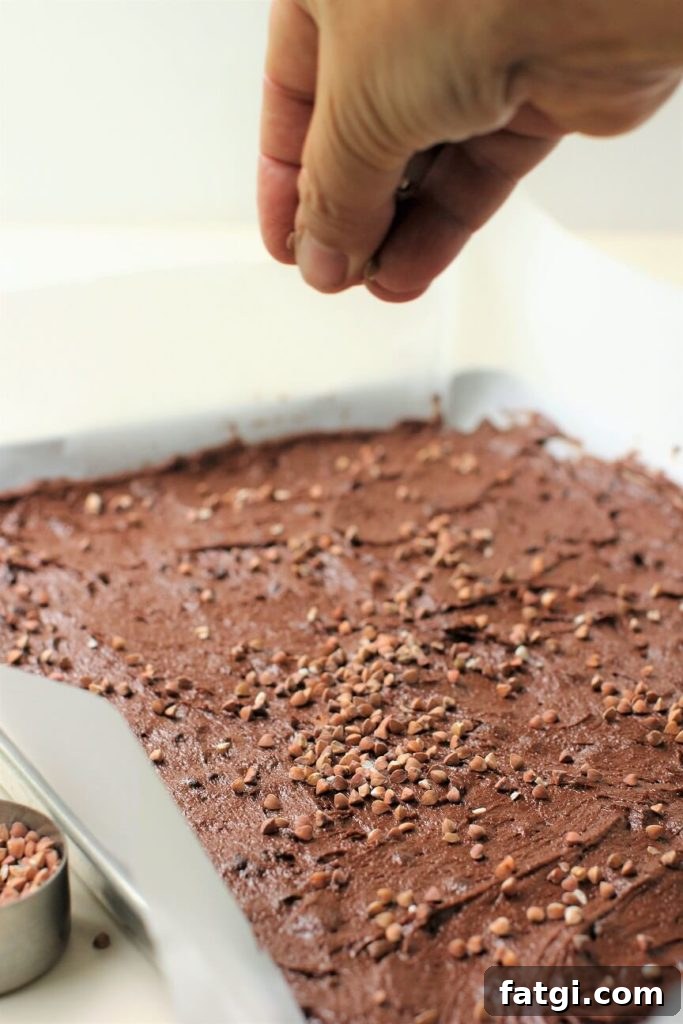 sprinkling the buckwheat groats on the brownie brittle batter