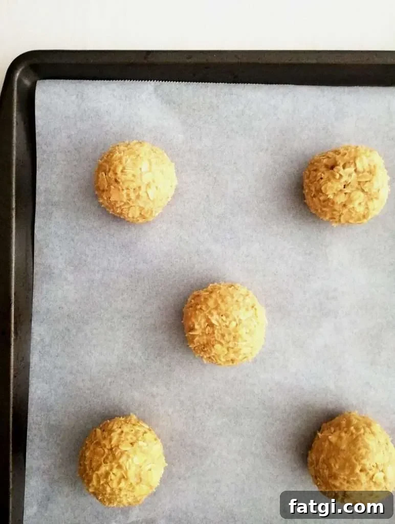 oatmeal cookie dough balls on parchment lined baking sheet overhead image