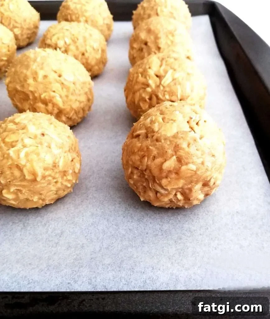 oatmeal cookie dough balls on baking sheet side view