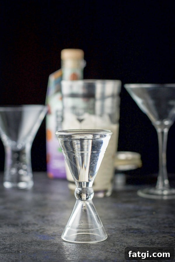 Vanilla vodka measured out with the bottle, shaker and glasses