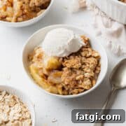 Homemade Gluten-Free Apple Crisp Recipe 5 A bowl of gluten free apple crisp with a scoop of vanilla ice cream on top.
