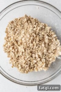 Homemade Gluten-Free Apple Crisp Recipe 7 Streusel topping in a glass bowl.