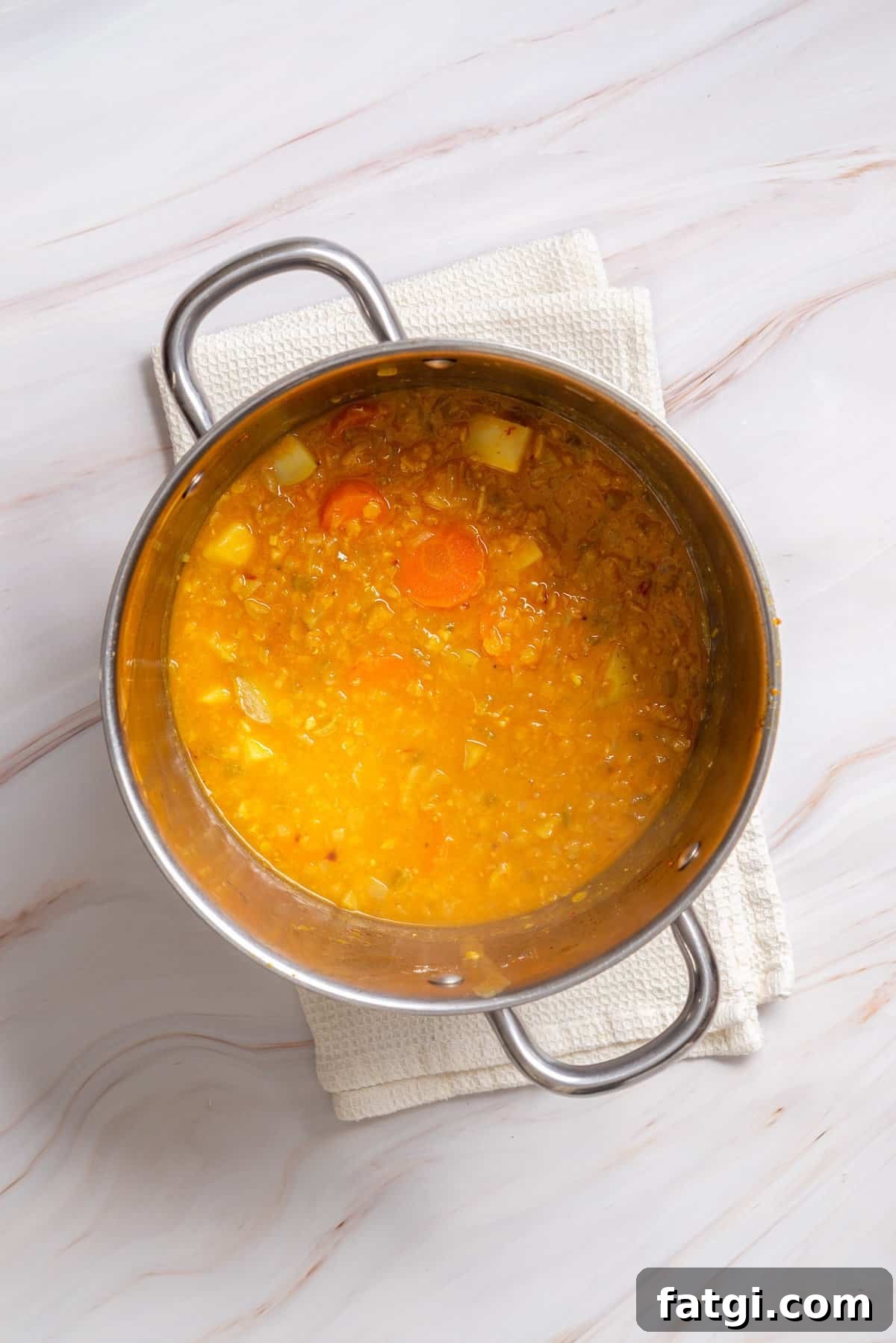 Simmered mulligatawny soup in a large pot.