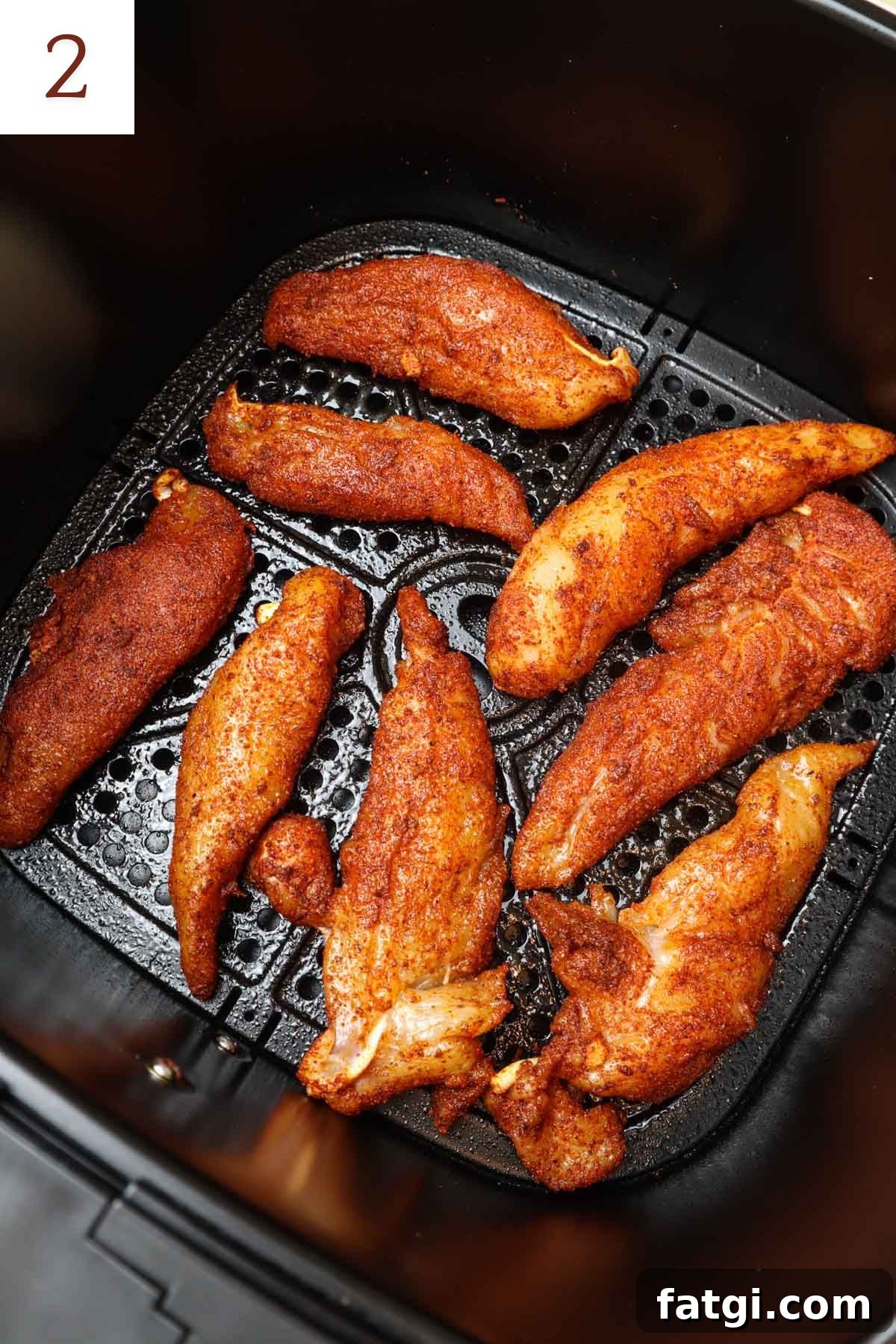 seasoned chicken tenders in an air fryer before they're cooked.