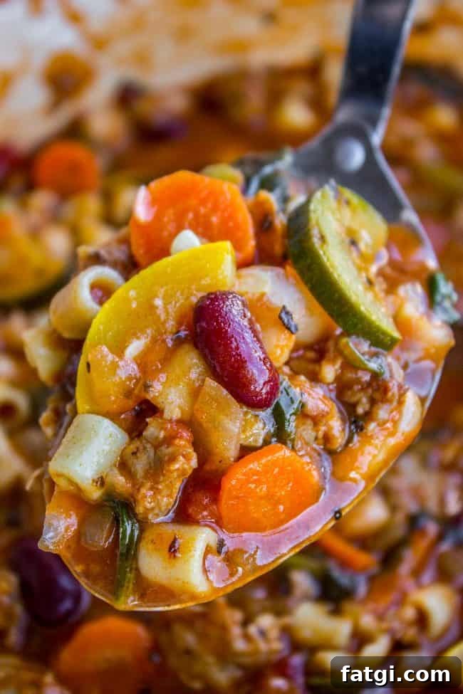 spoonful of minestrone soup with beans.